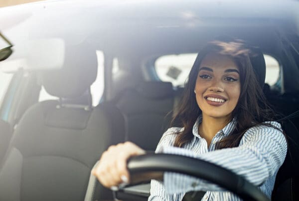 Request Auto ID Card - Woman in Car Driving to Work with the Sun on the Dashboard